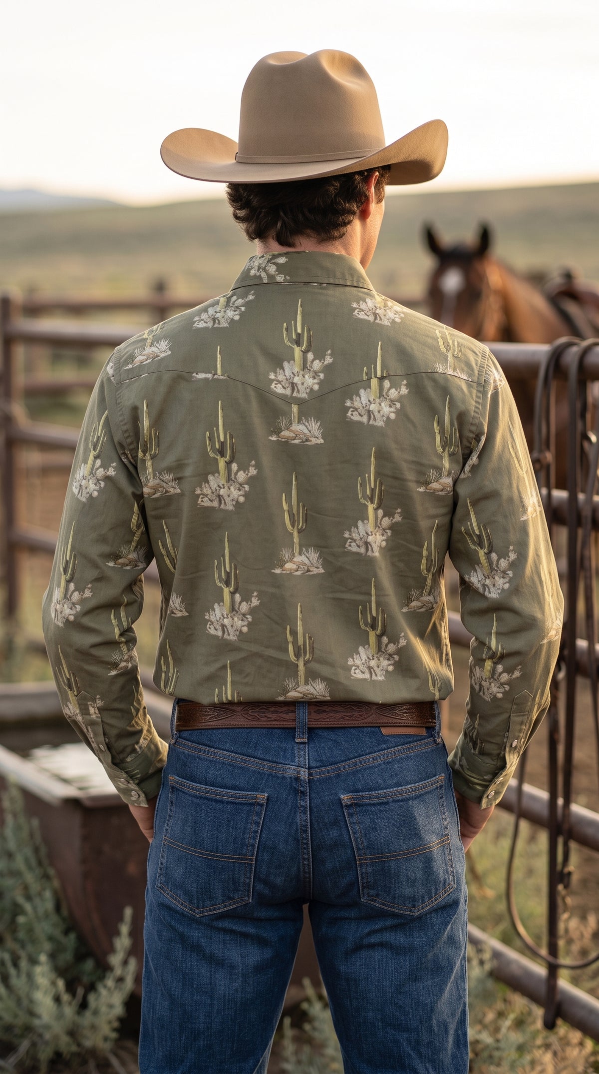 Back view of men's olive green western shirt highlighting single-point yoke and desert cactus pattern