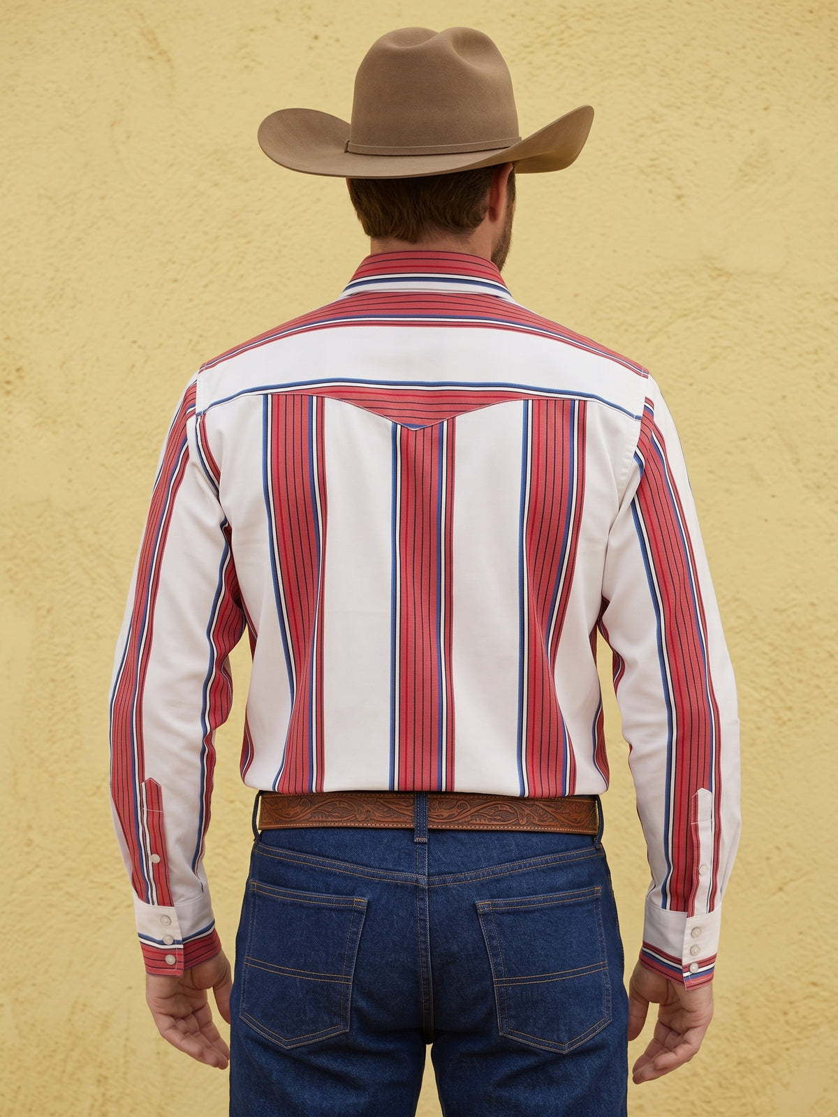 Rear view of man wearing Pecos Western white, red, and blue vertical striped Western shirt showing horizontal striped back yoke